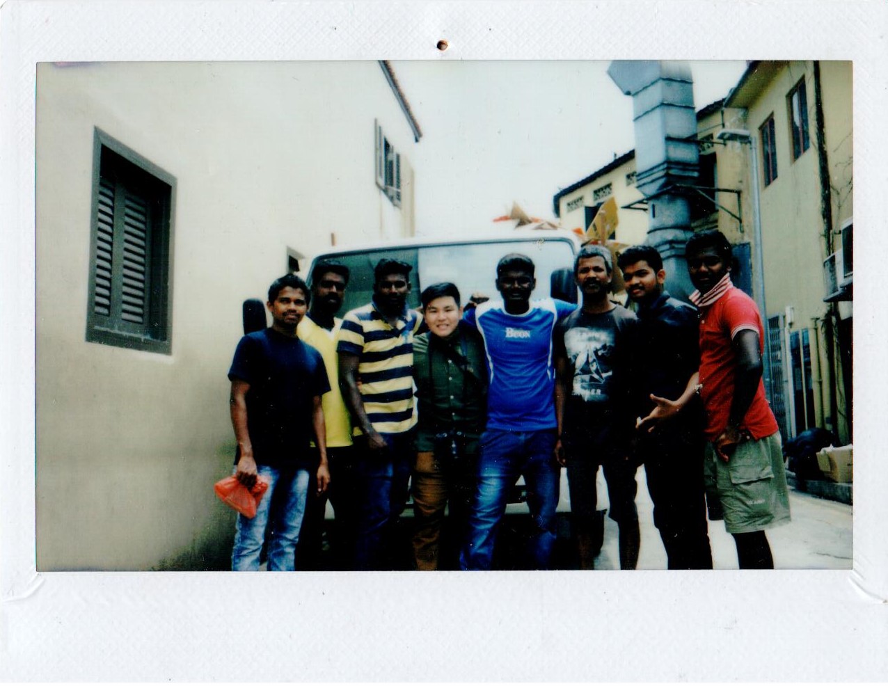 A group of workers posing in an alley