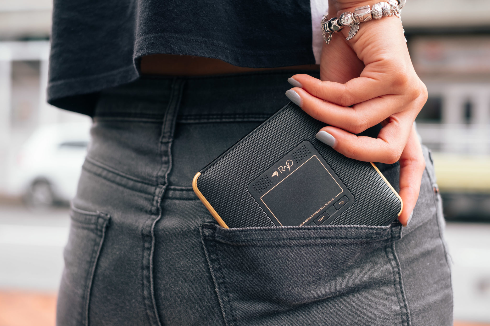 The Canon Rayo S1 projector tucked into a back pocket of jeans