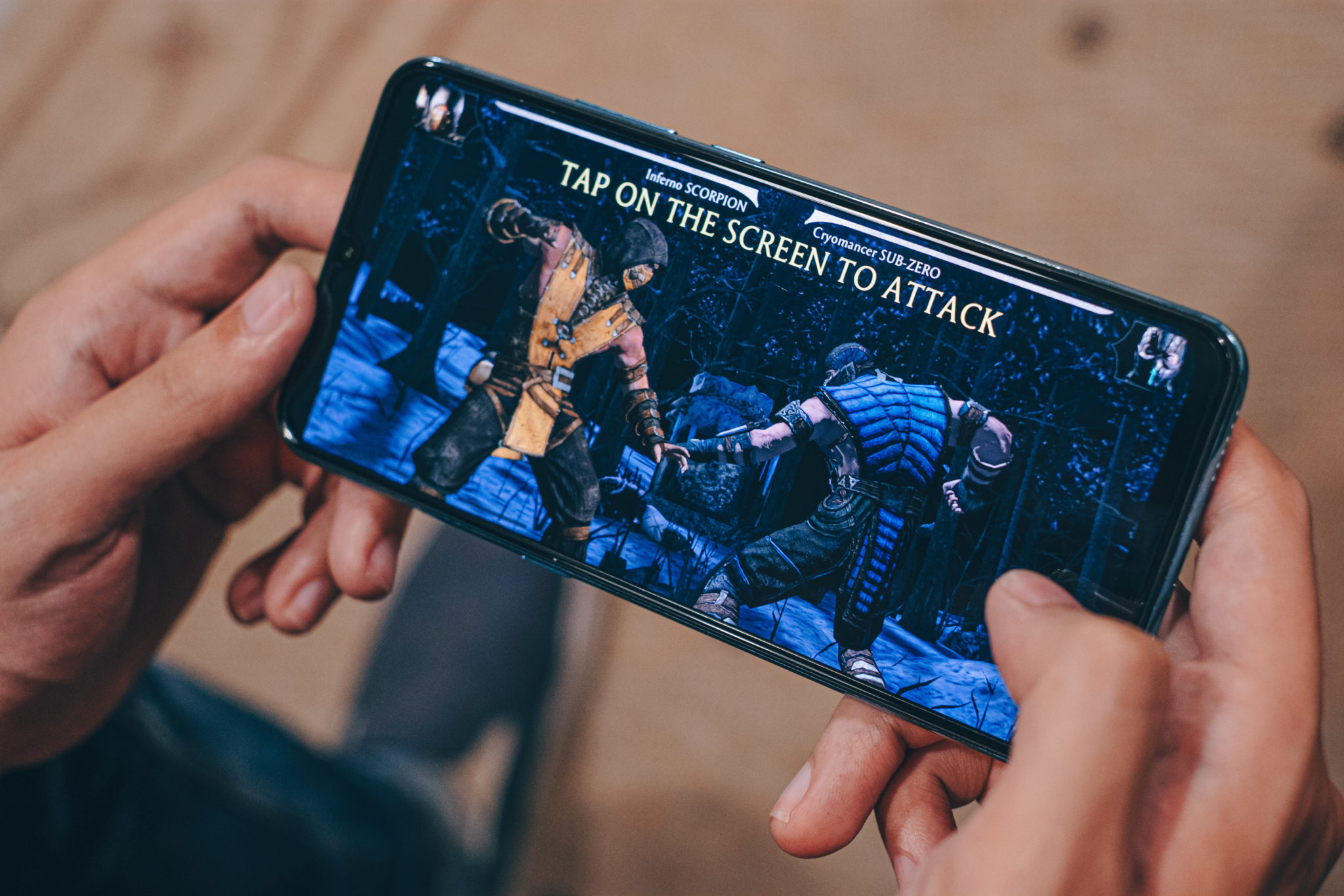 Hands holding the Vivo S1 sideways while playing a fighting game