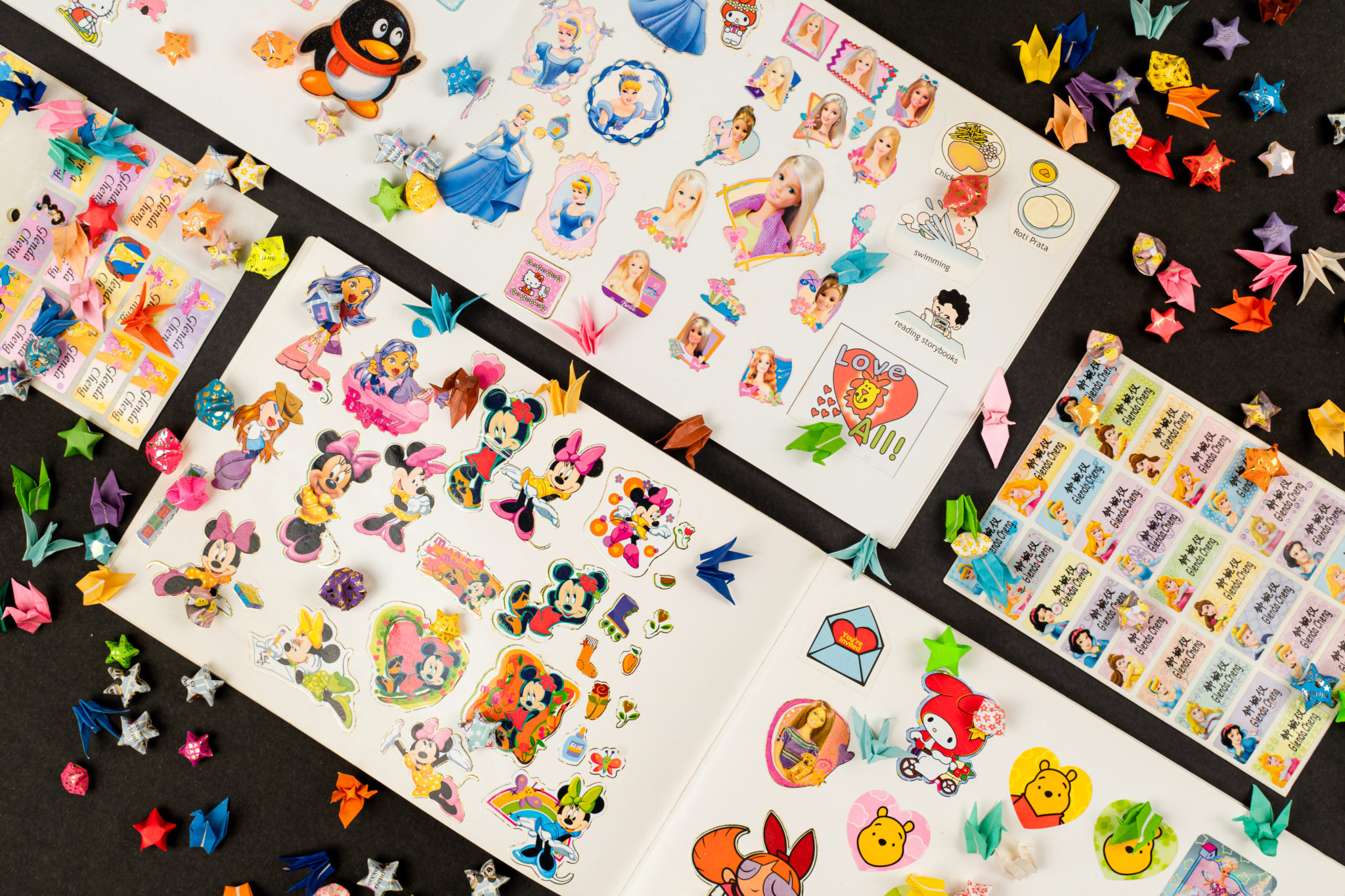 Sheets of cartoon stickers and origami stars spread out