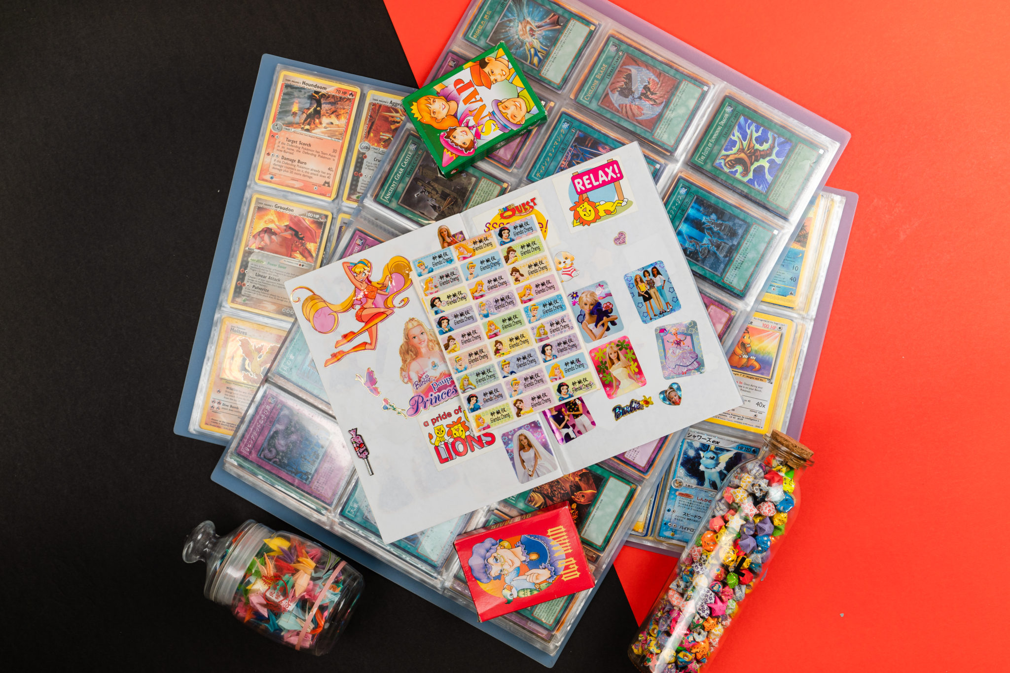 A collection of trading cards and sticker sheets in a binder