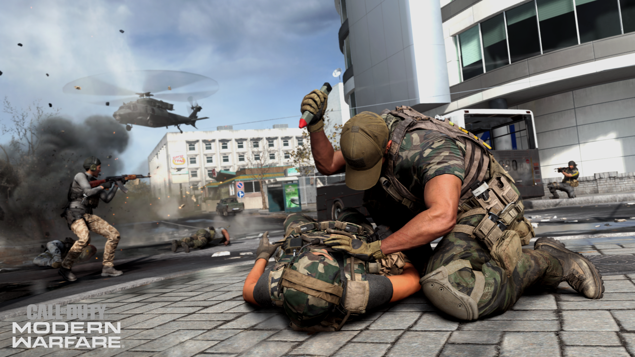 A soldier restraining an enemy on the ground with a helicopter overhead in Call of Duty: Modern Warfare