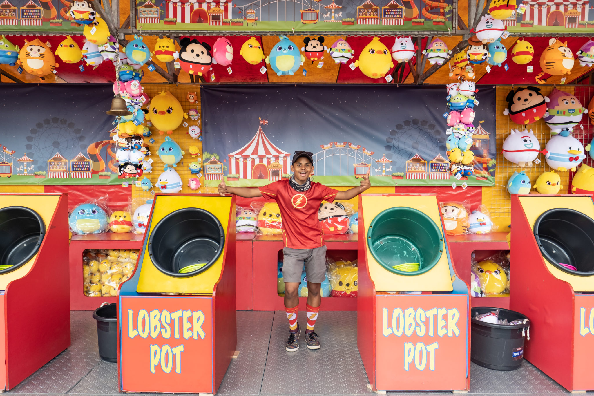 A colourful carnival game booth with lobster pots at Uncle Ringo