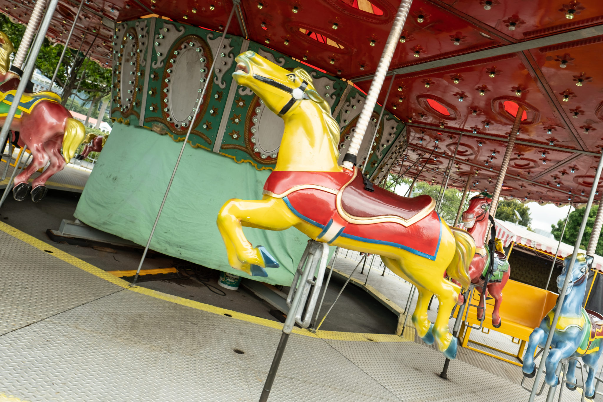 A carousel horse in red and yellow at the Uncle Ringo carnival