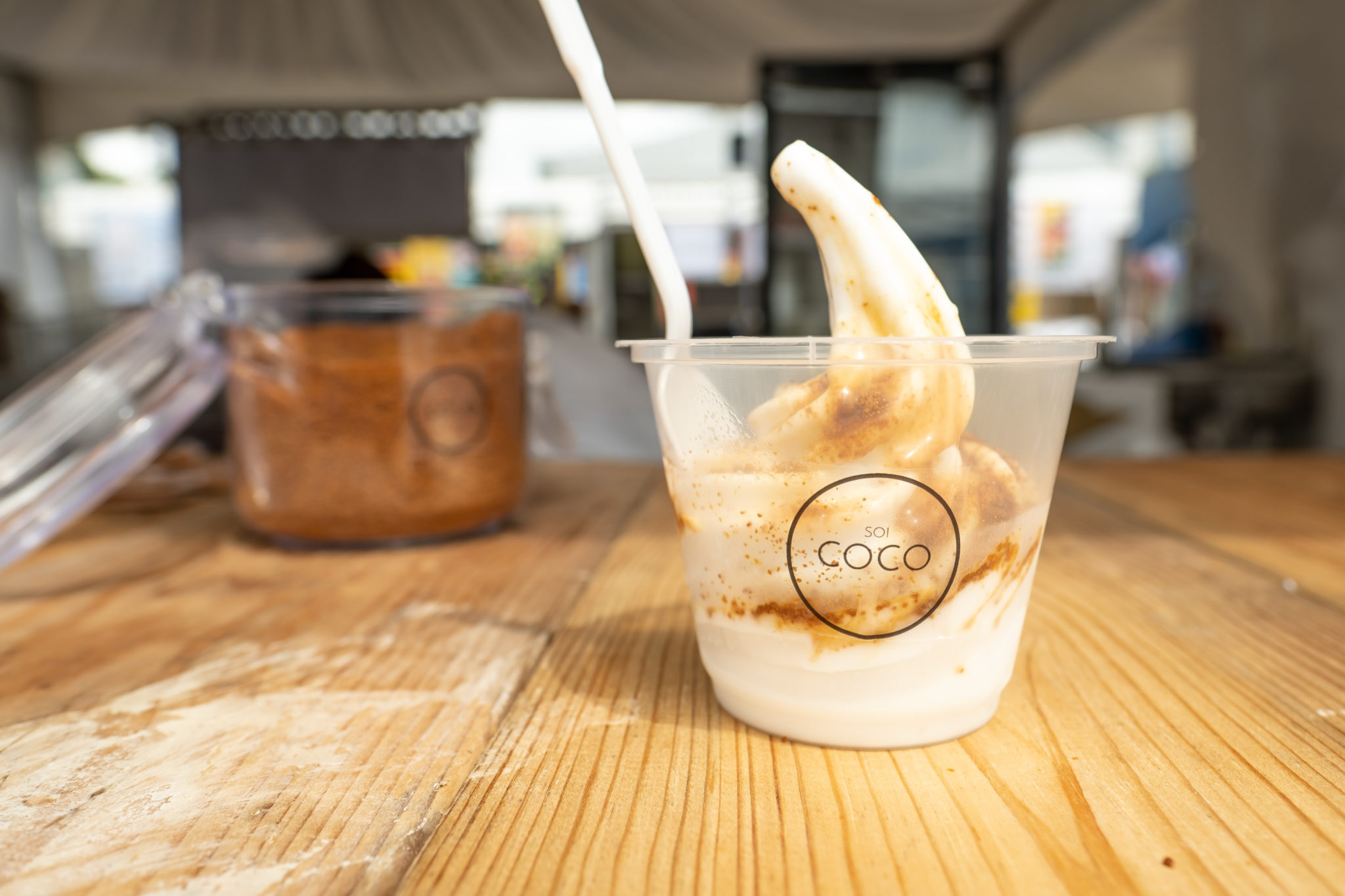 A cup of coconut soft serve with a gula melaka topping