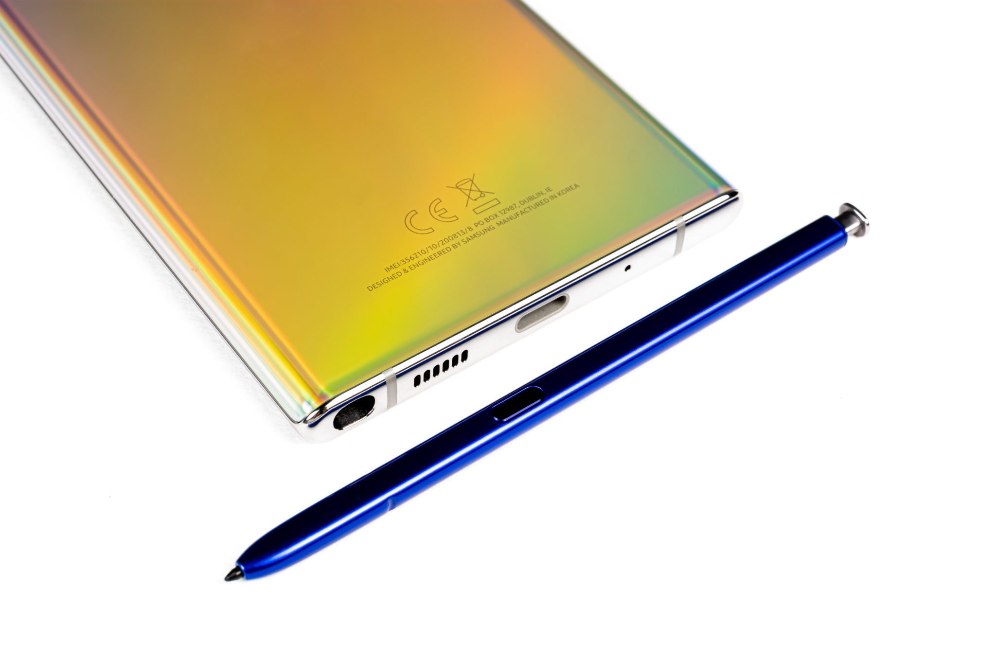 The Galaxy Note 10+ lying beside its blue S Pen