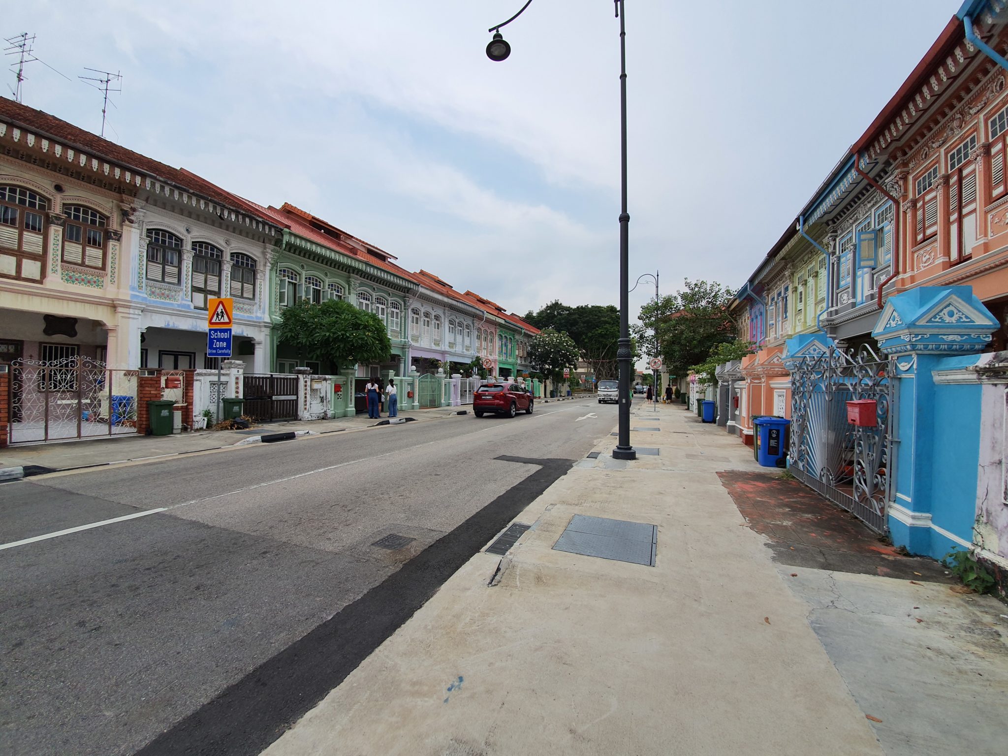 A street of colourful shophouses under a pale sky, shot with the Note 10+