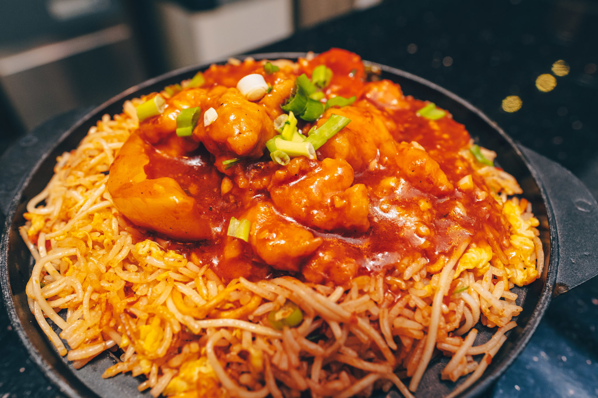 A sizzling plate of Triple Szechwan Rice topped with chilli chicken