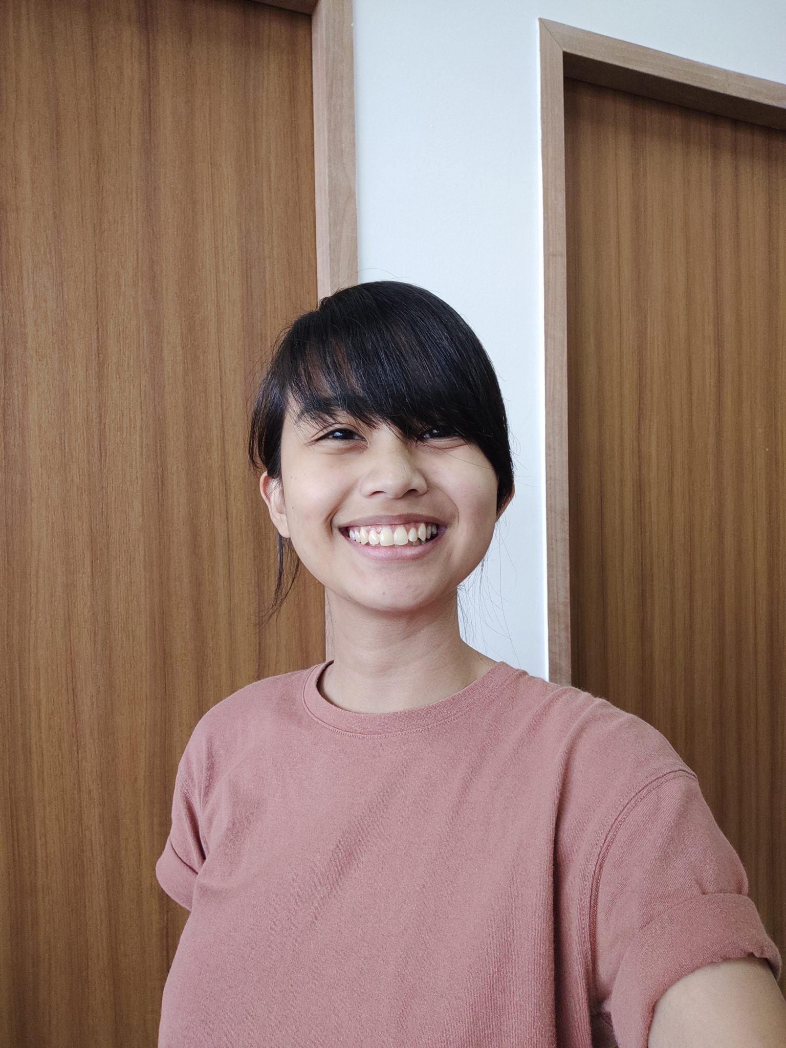 A smiling woman in a pink top, taken with the V17 Pro front camera