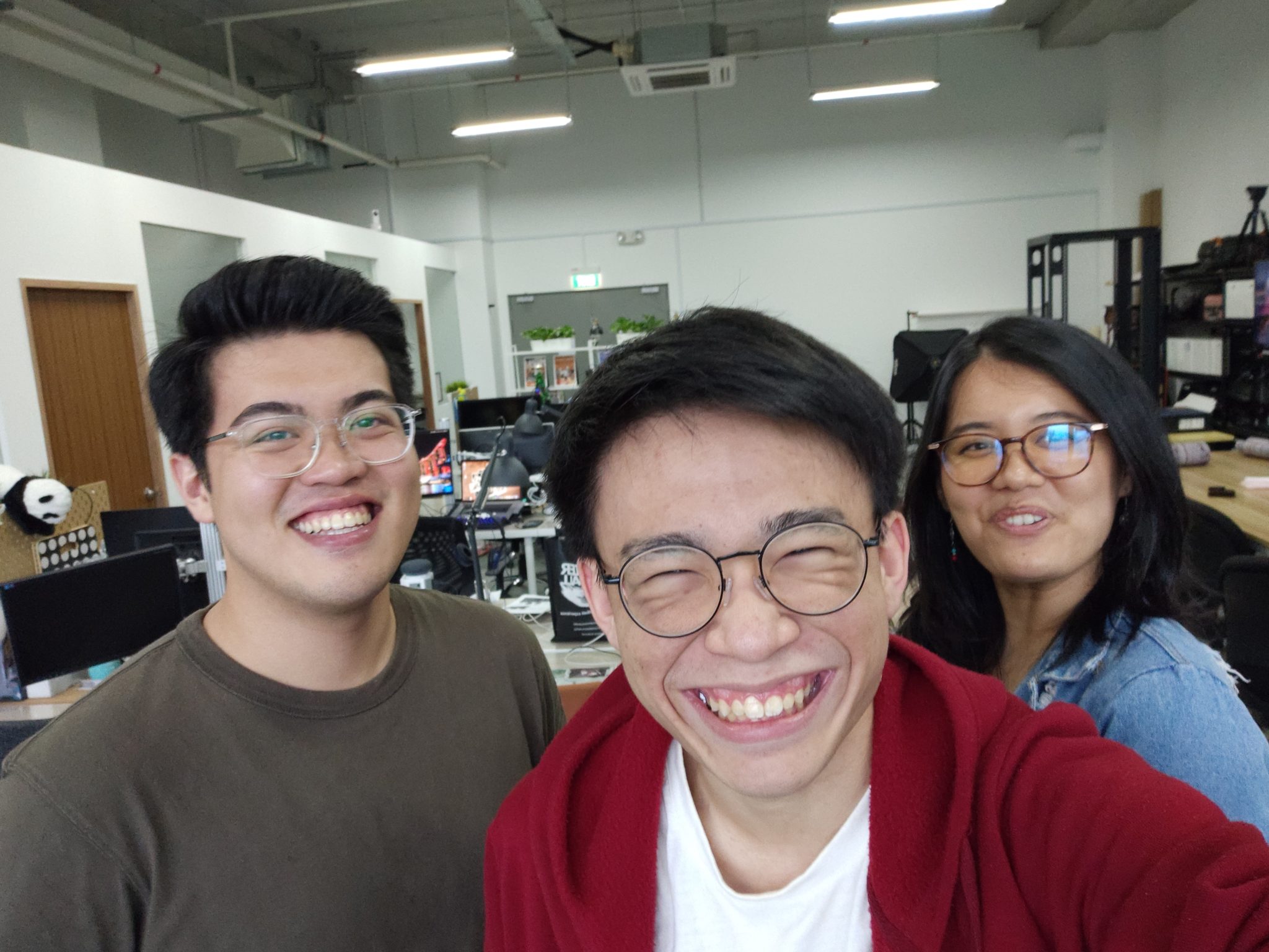 A selfie of three colleagues in an office, taken with the Vivo Nex 3