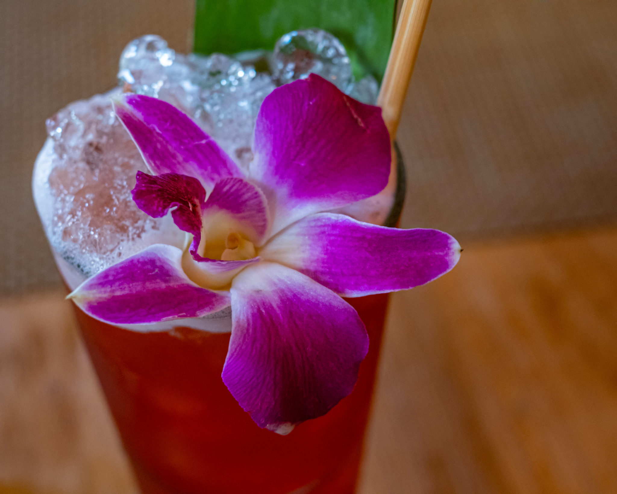 A Planter's Punch with crushed ice and a purple orchid