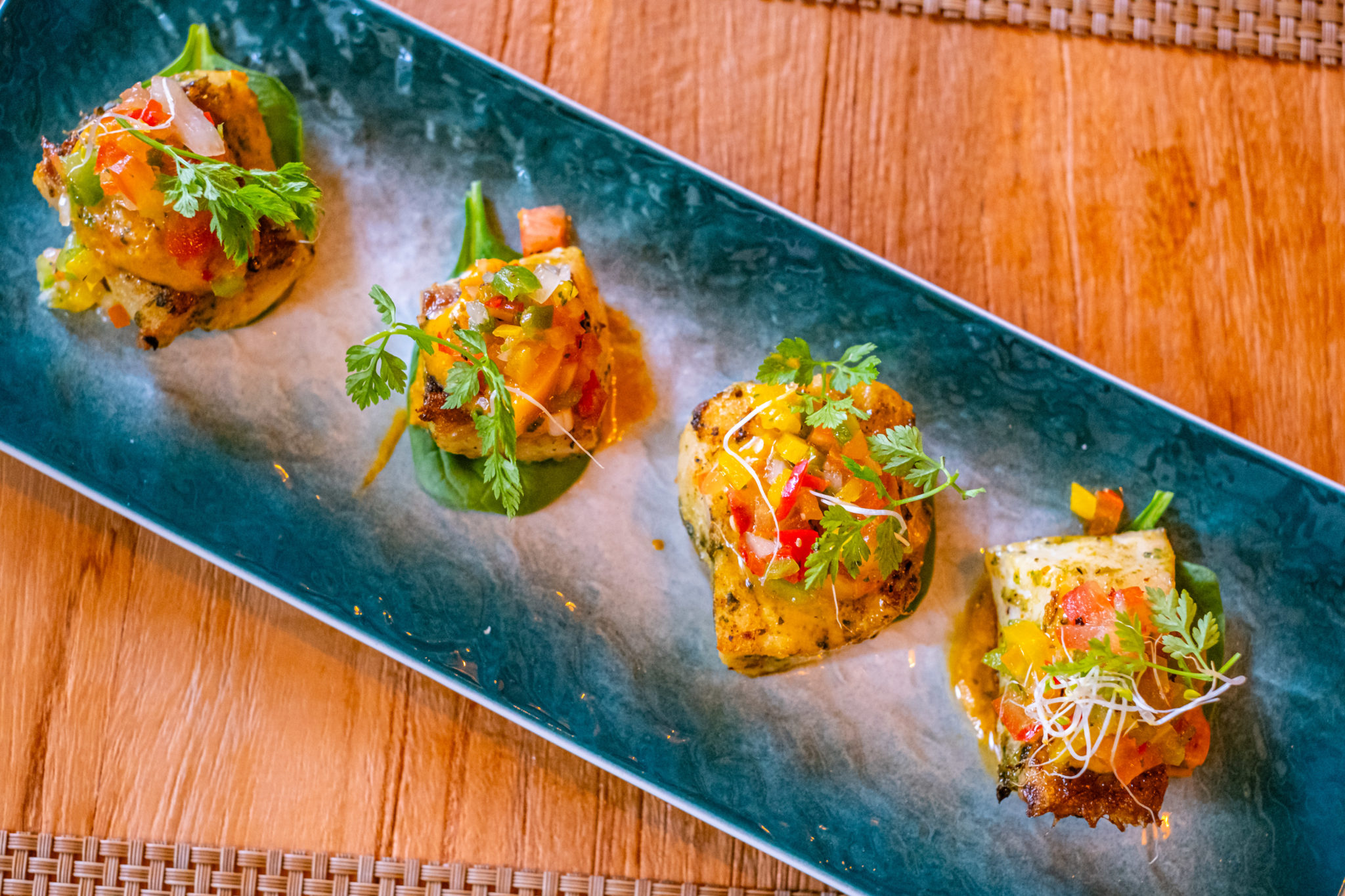 Colourful vegetable bites on a long blue plate