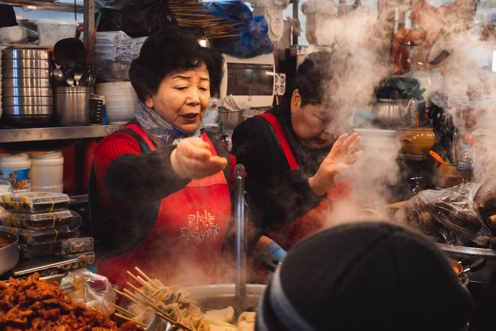 Street-food stall holders cooking in a cloud of steam, shot on the Nikon Z 50