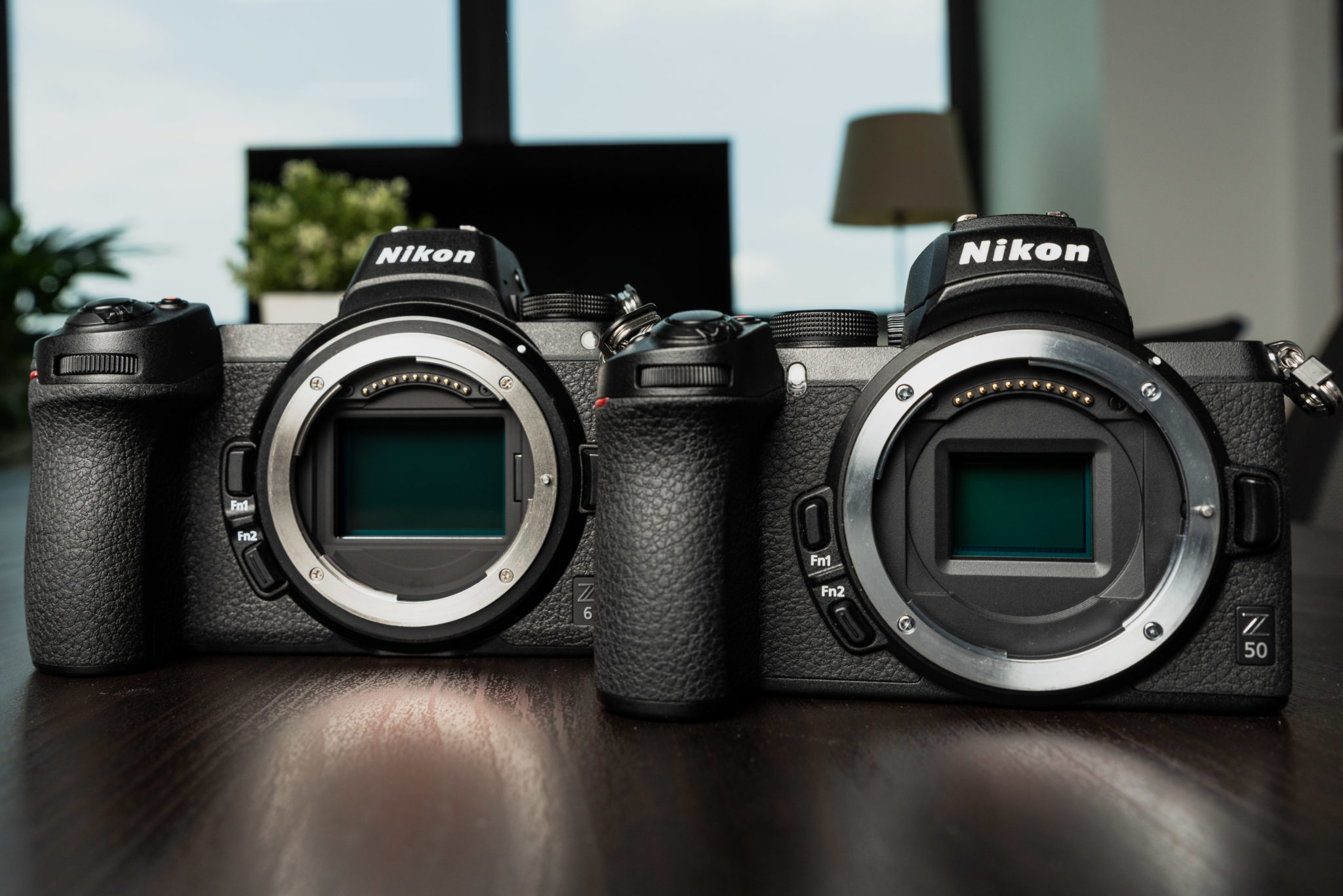 The Nikon Z 50 beside the Nikon Z 6, both with their lens mounts open