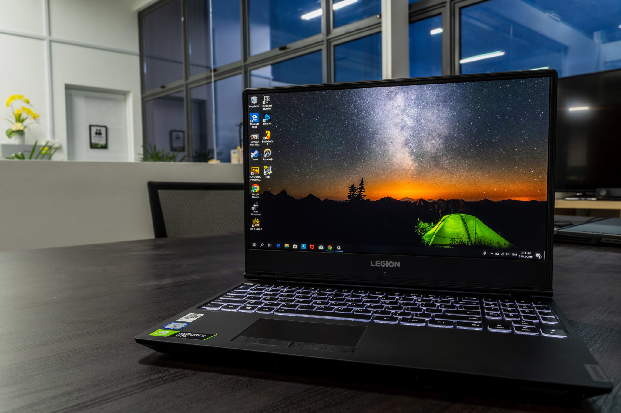 A Legion Y540 open on a desk with a night-sky wallpaper on its screen