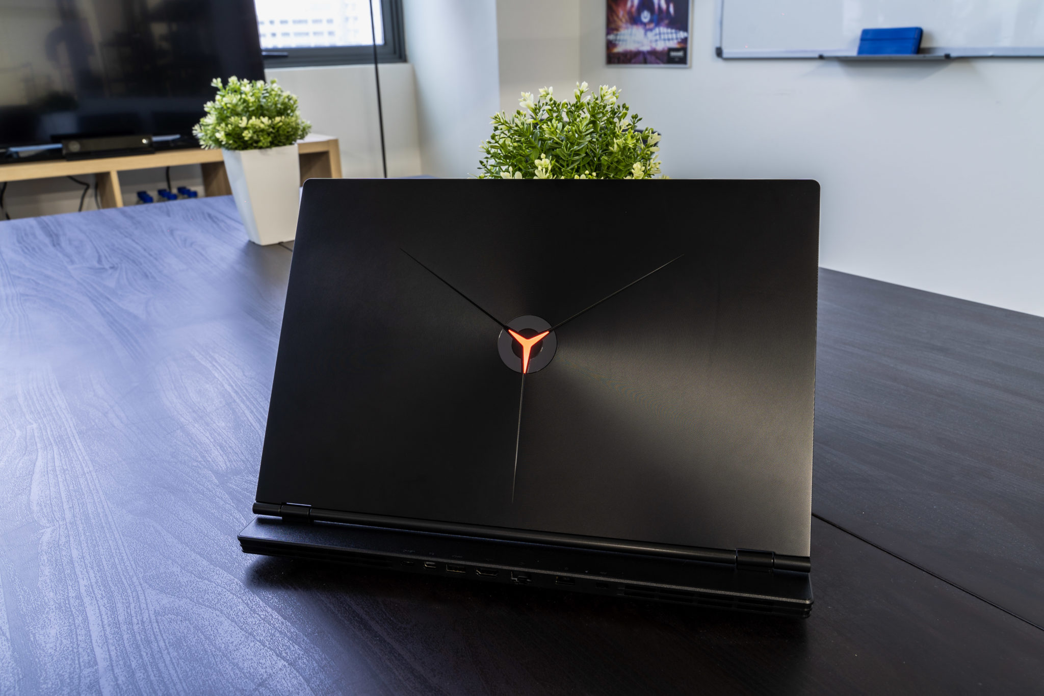 The lid of a Legion laptop with its glowing Y logo