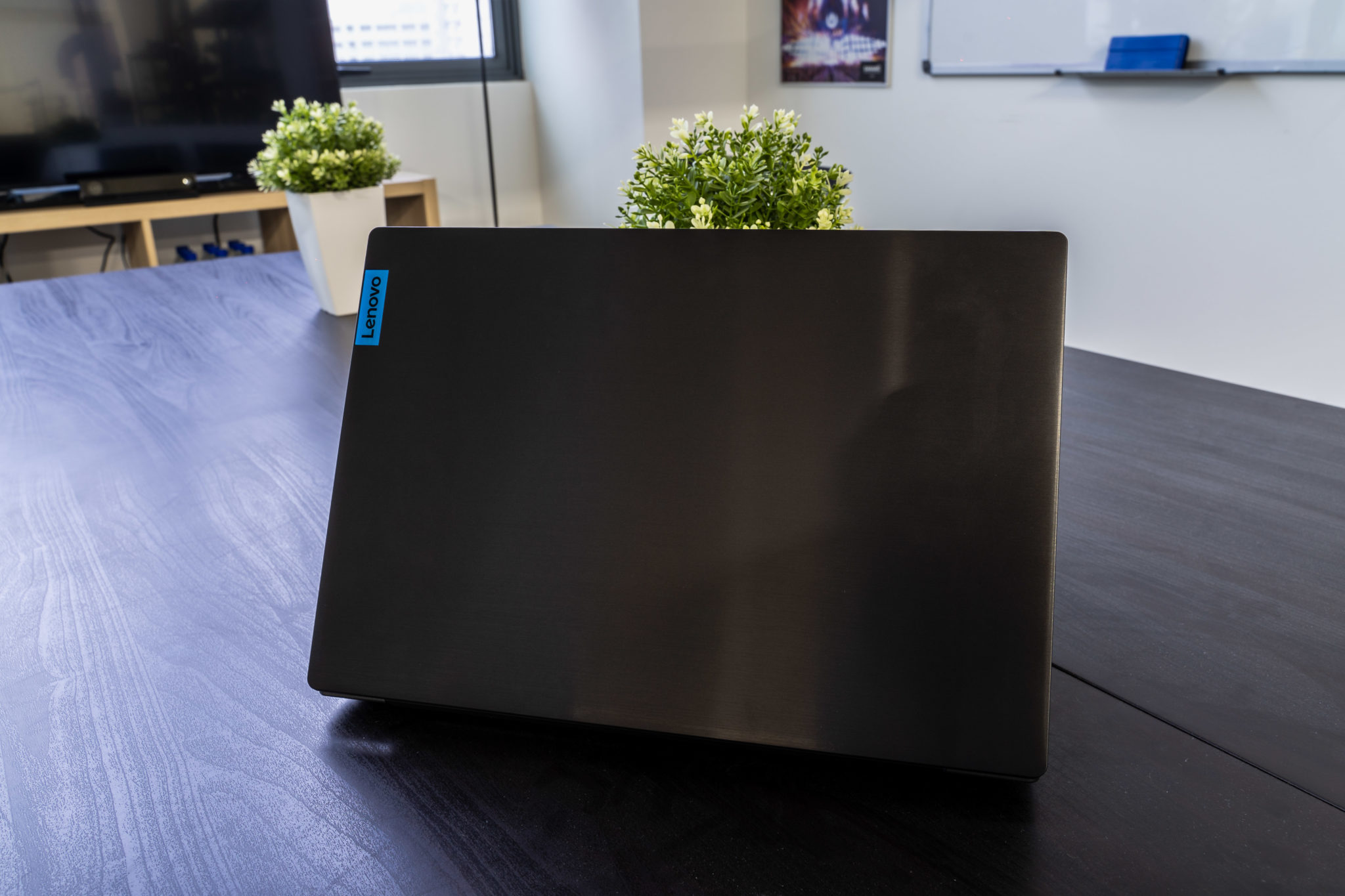 The brushed metal lid of the IdeaPad L340 Gaming with a small blue Lenovo logo