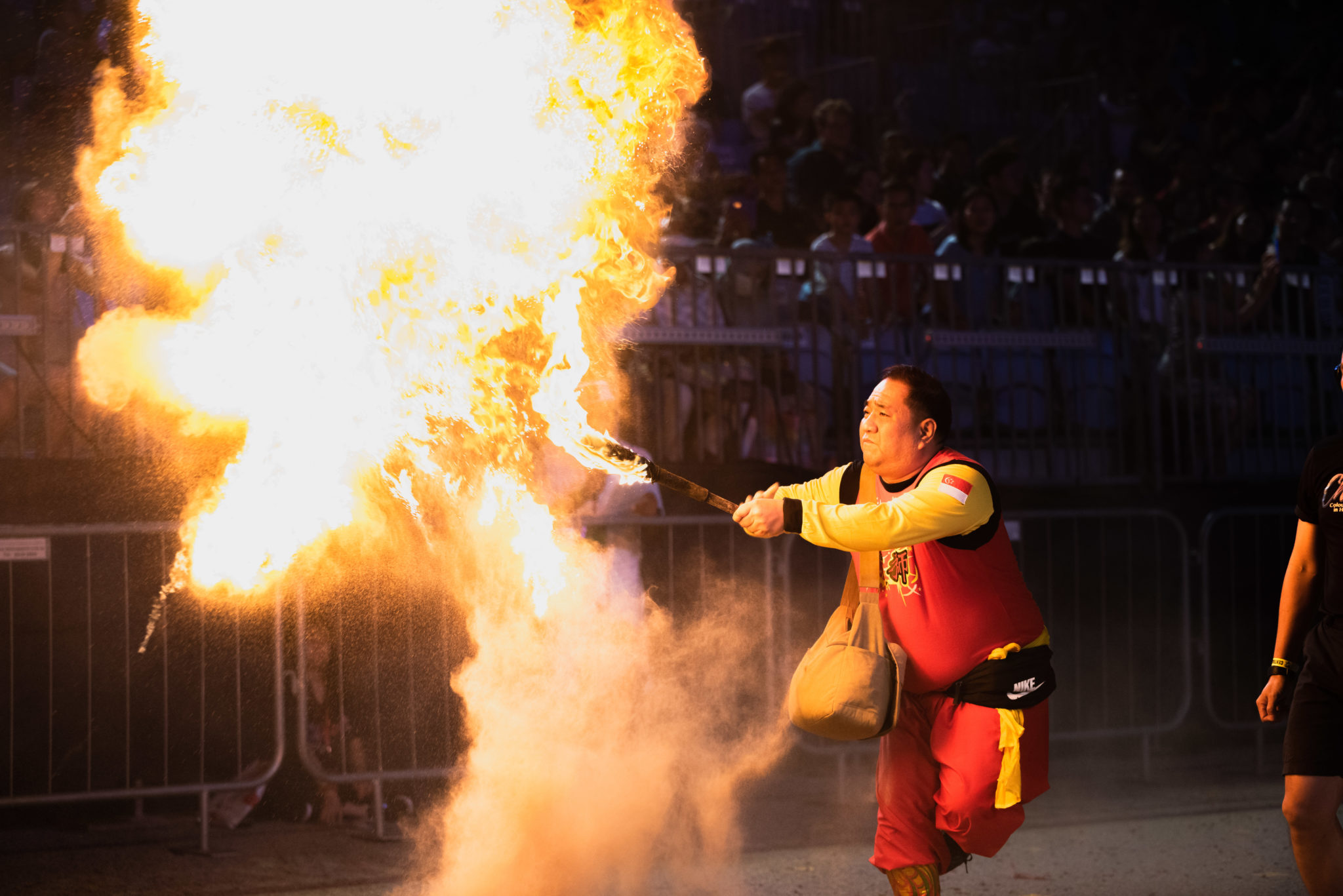 A performer blowing a huge burst of fire at Chingay