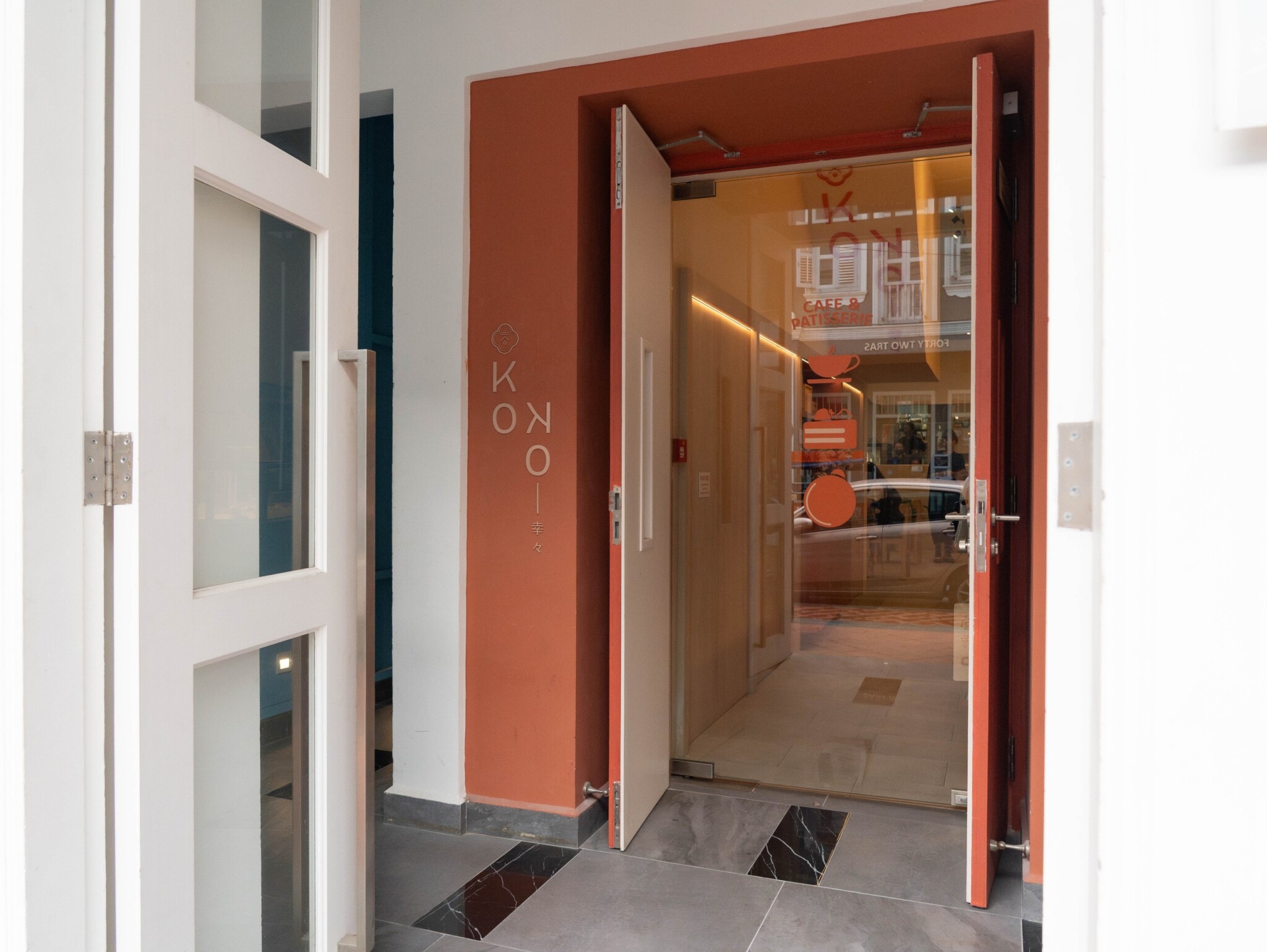The entrance to KOKO Cafe & Patisserie displays its name above the doorway.