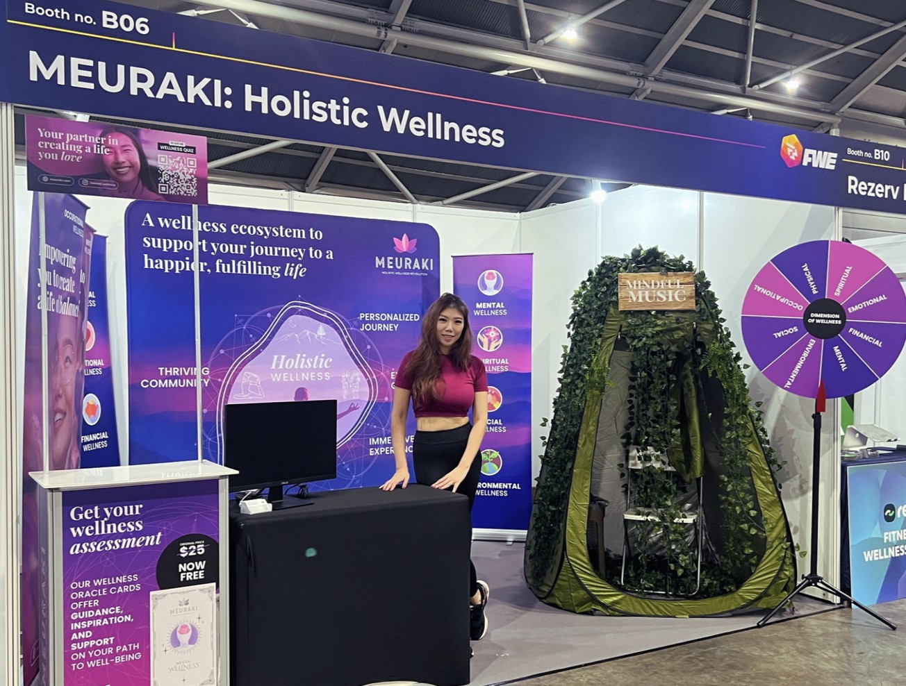 Michelle Ngiam stands at a purple MEURAKI exhibition booth.