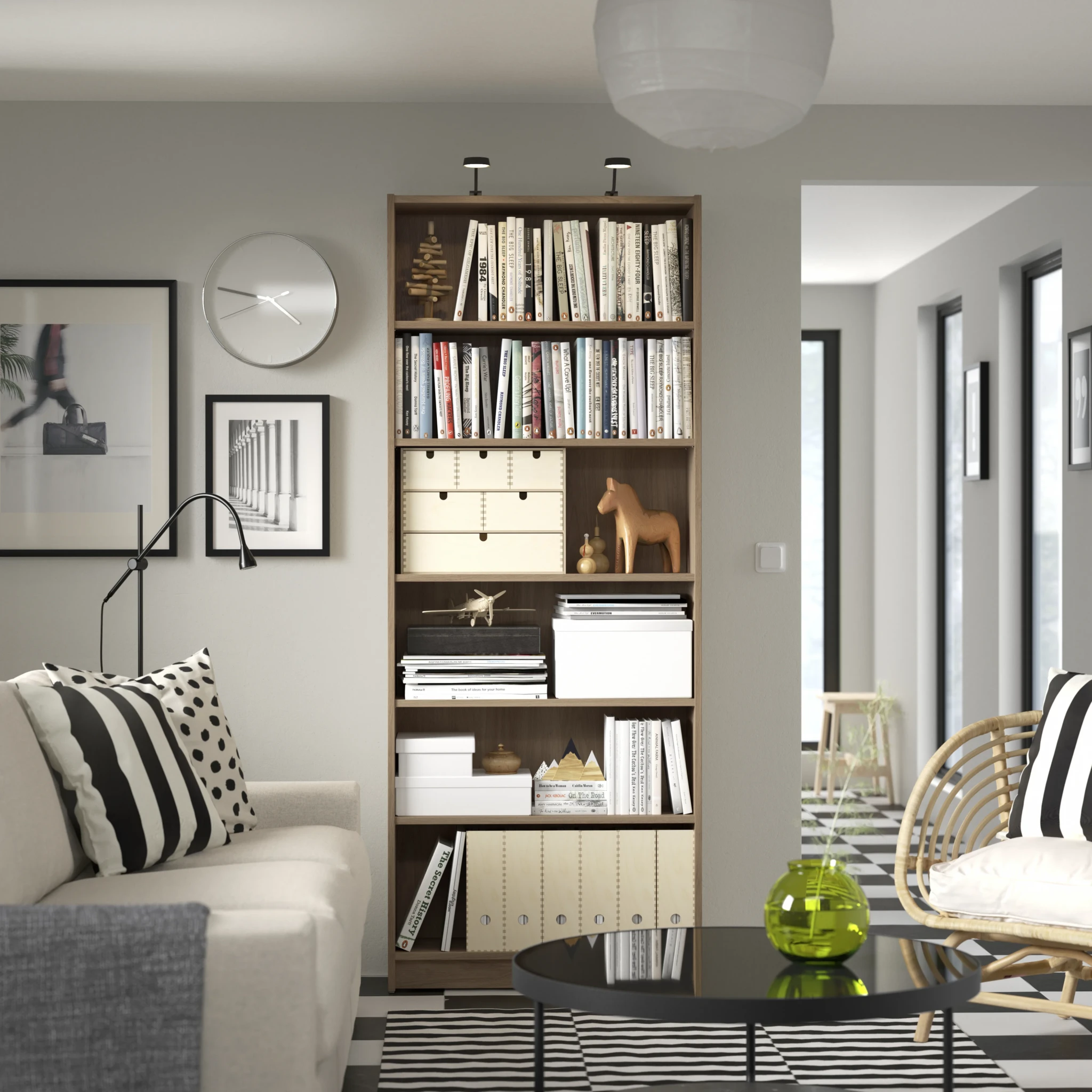 A living room with built-in wooden shelving, a beige armchair and patterned cushions from IKEA Singapore's Home Design Showcase