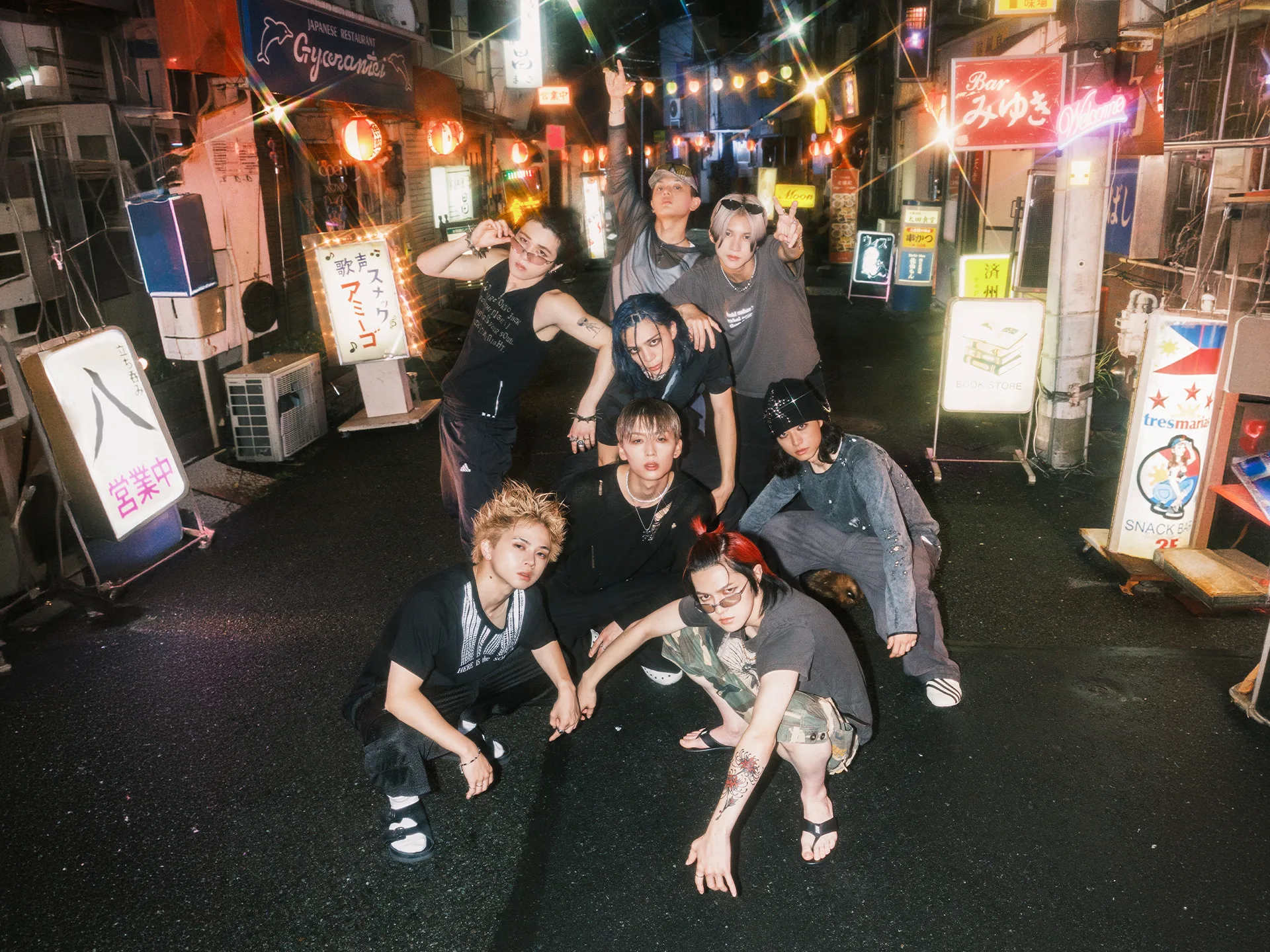 ONE OR EIGHT posing on a neon-lit street ahead of their Black Clover ending theme release