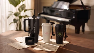 Jay Chou and Starbucks collaboration tumblers arranged on sheet music beside a piano