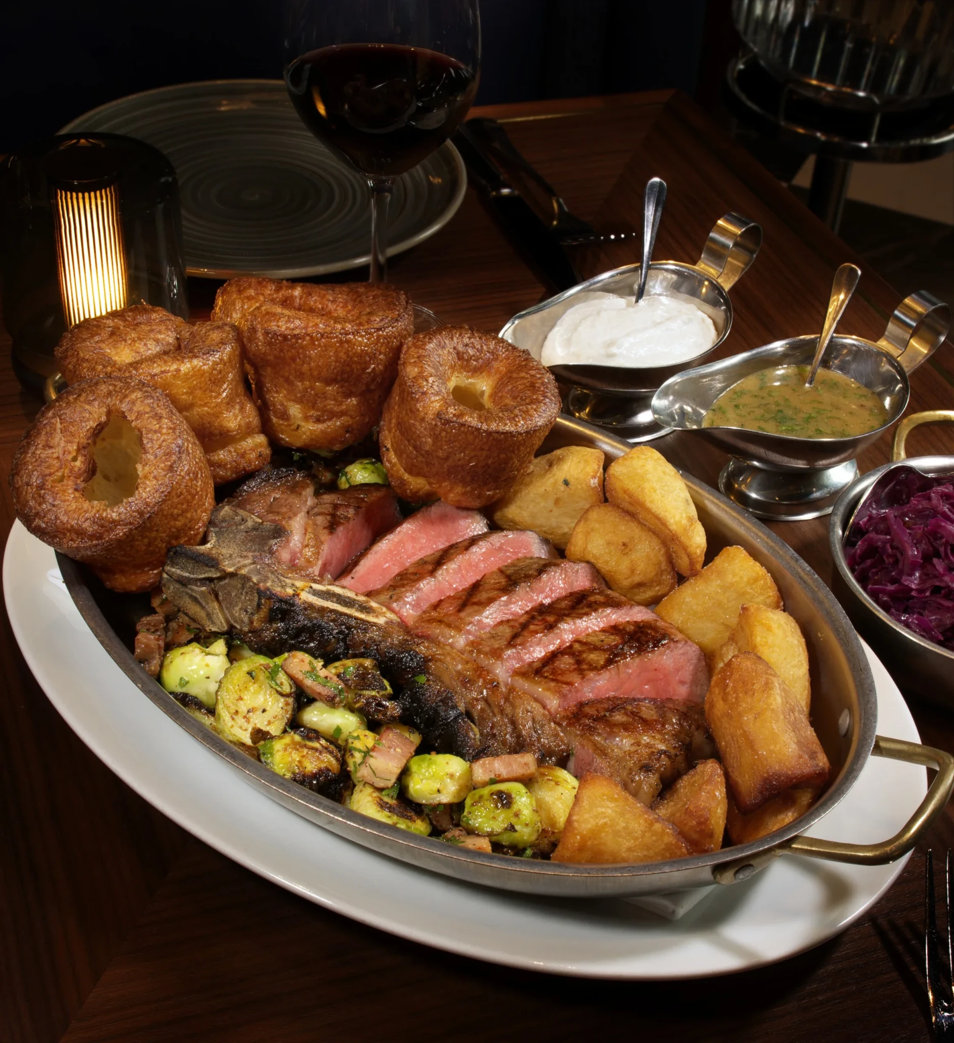Roast beef and wood-fired steak served with Yorkshire puddings, grilled vegetables and house sauces