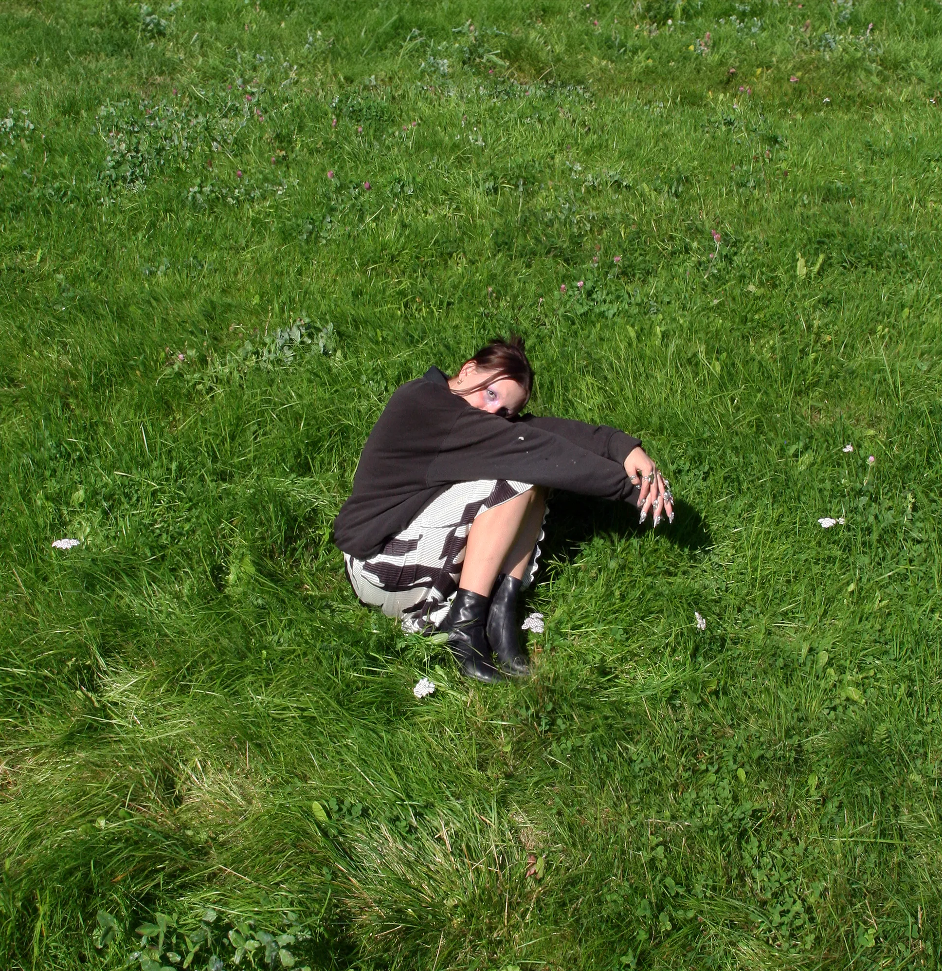 googly eyes lying on grass in a deliberate pose for the 5 More Minutes press shoot