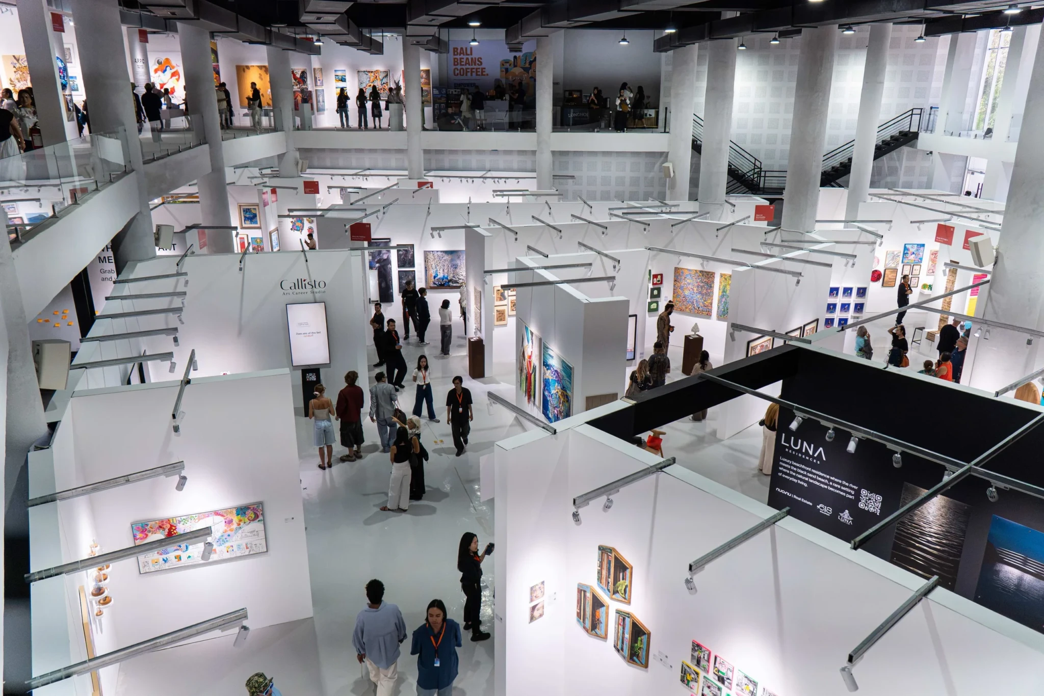 Gallery booths and artworks across the multi-level exhibition floor of Art & Bali 2026