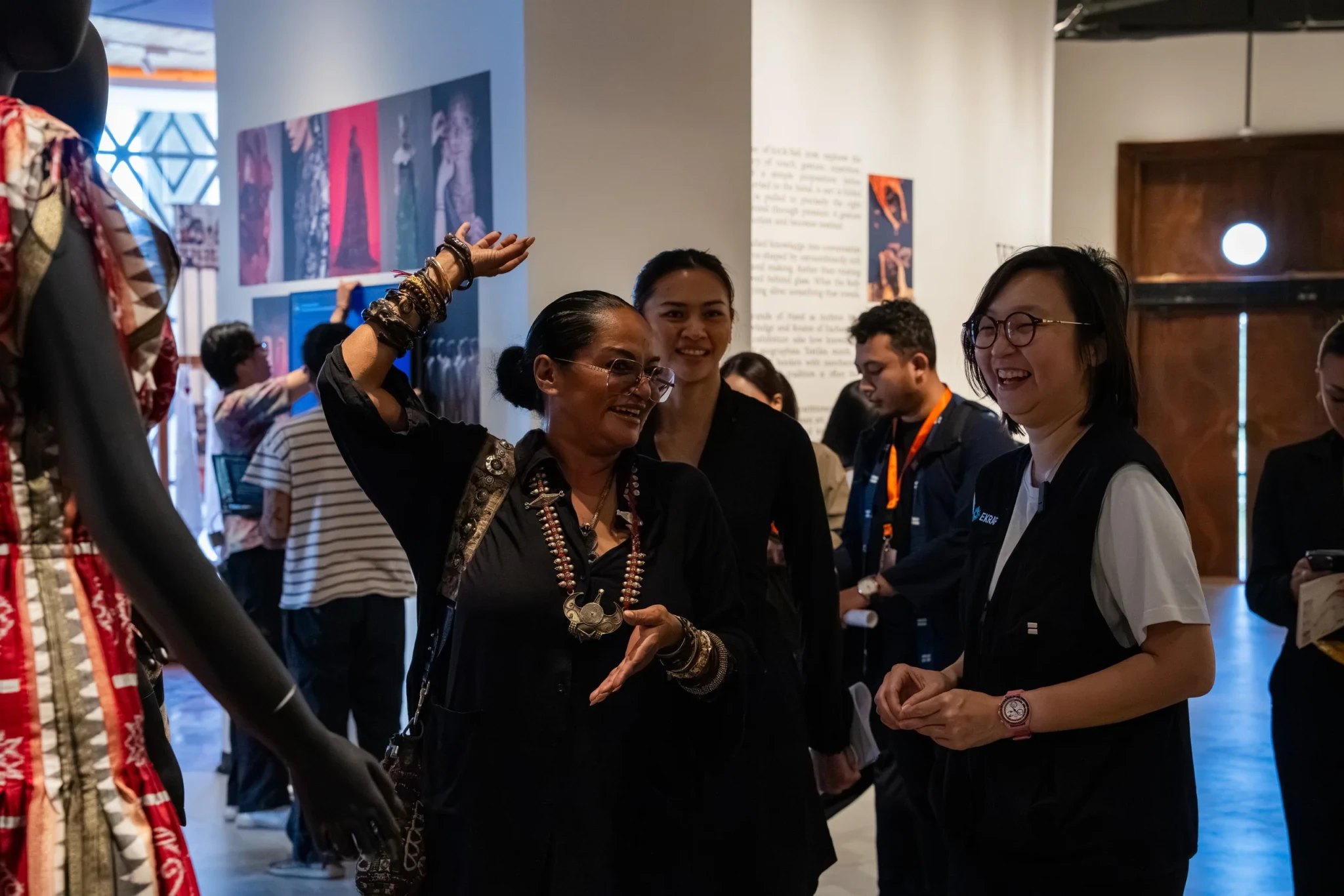 Visitors walking through the textile and contemporary art displays at the fair