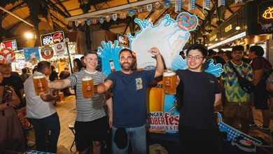 Participants taking part in the Stein Holding Challenge at ERDINGER Oktoberfest 2025 at Lau Pa Sat