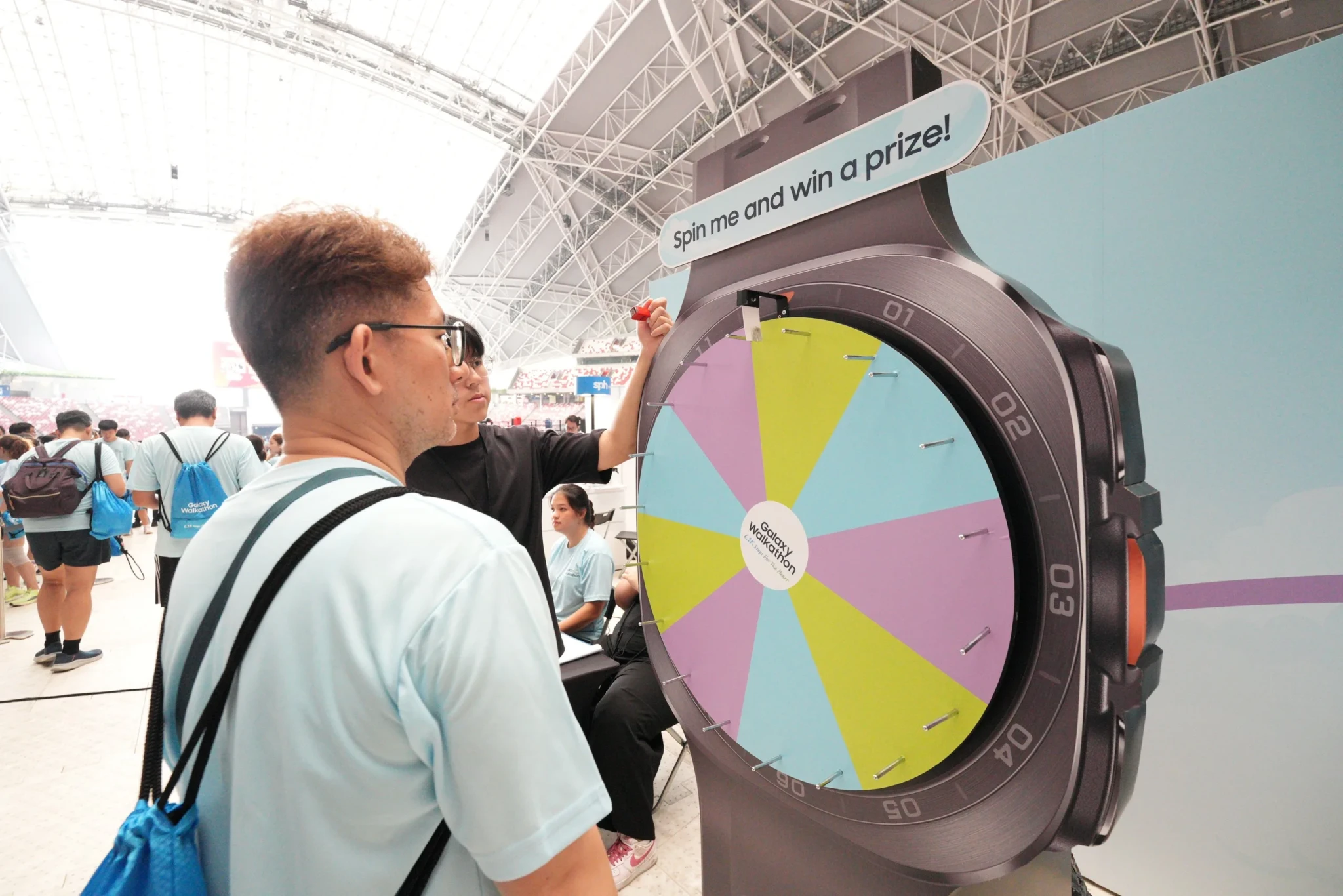 A participant spins a prize wheel at the Walkers' Village during the Galaxy Walkathon