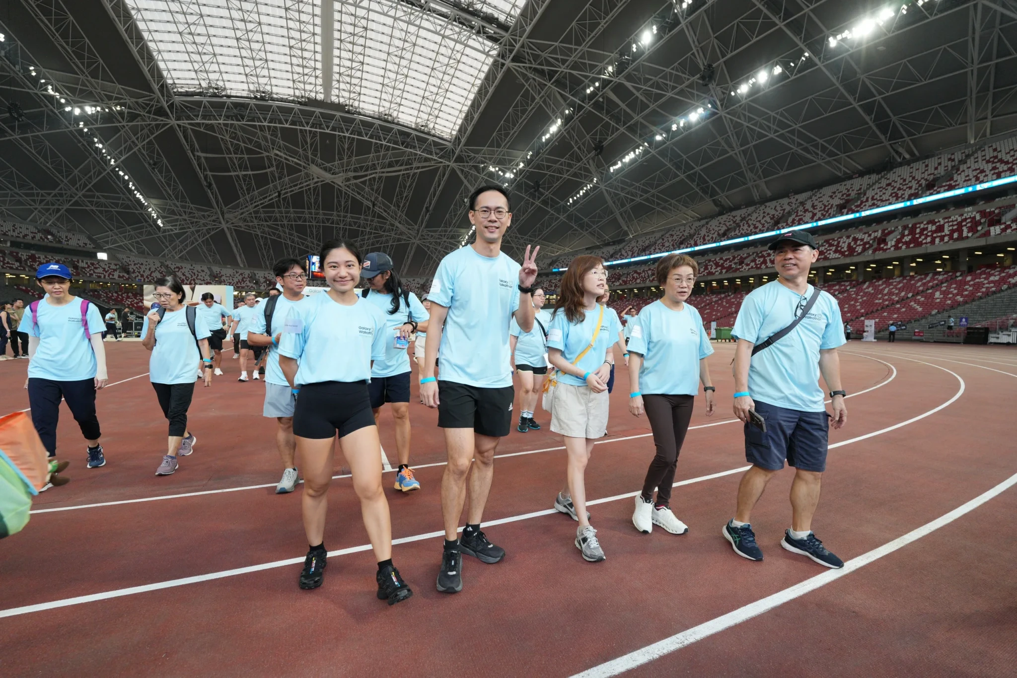 Galaxy Walkathon participants walk on the stadium track at The Kallang