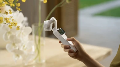 A creator films in a sunlit garden with the DJI Osmo Pocket 4P in pearl white