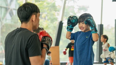 A child practises punches during a kids' martial arts training session