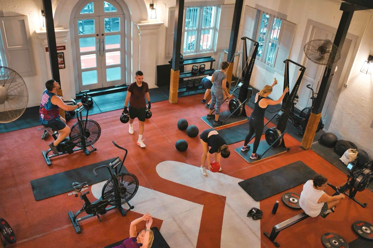 Pairs of participants working through fitness exercises side by side in a training studio