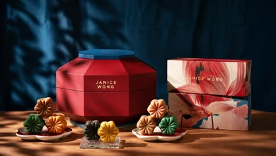 Janice Wong flower-shaped mooncakes beside a red octagonal gift box