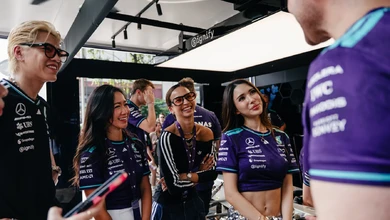 BABYMONSTER and Mercedes-AMG PETRONAS F1 Team representatives under the adidas Orchard Ignition canopy