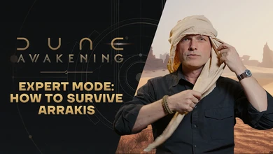John Hudson adjusts protective head wrapping in desert gear for the Dune: Awakening Expert Mode featurette