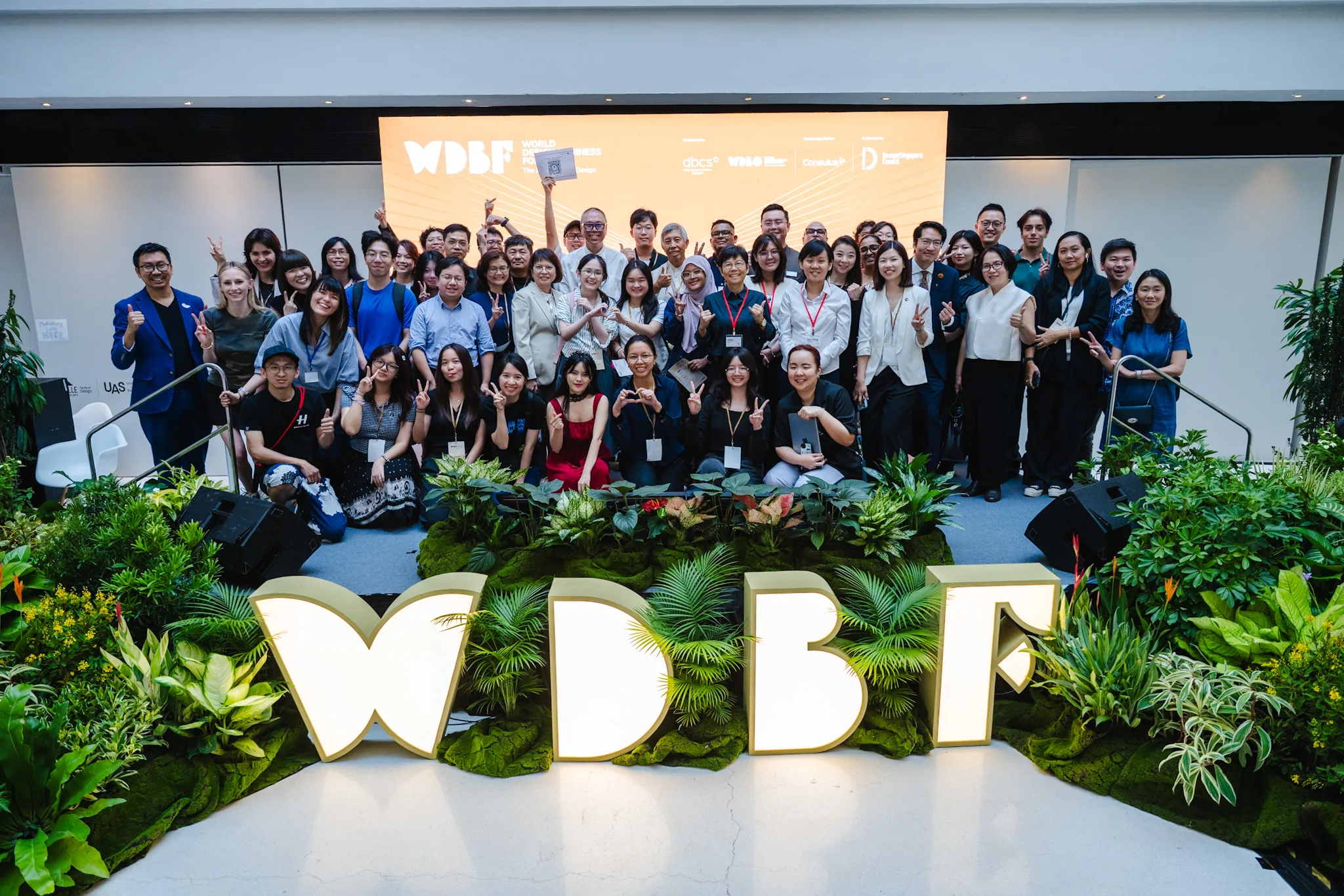 Delegates gathered beneath the illuminated WDBF letters at the World Design Business Forum
