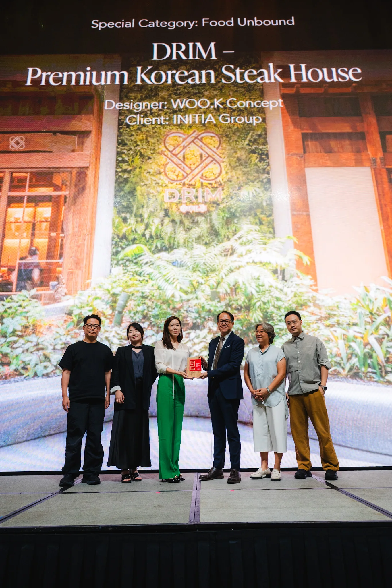 WOO.K Concept's design team and client representatives accept an award for DRIM