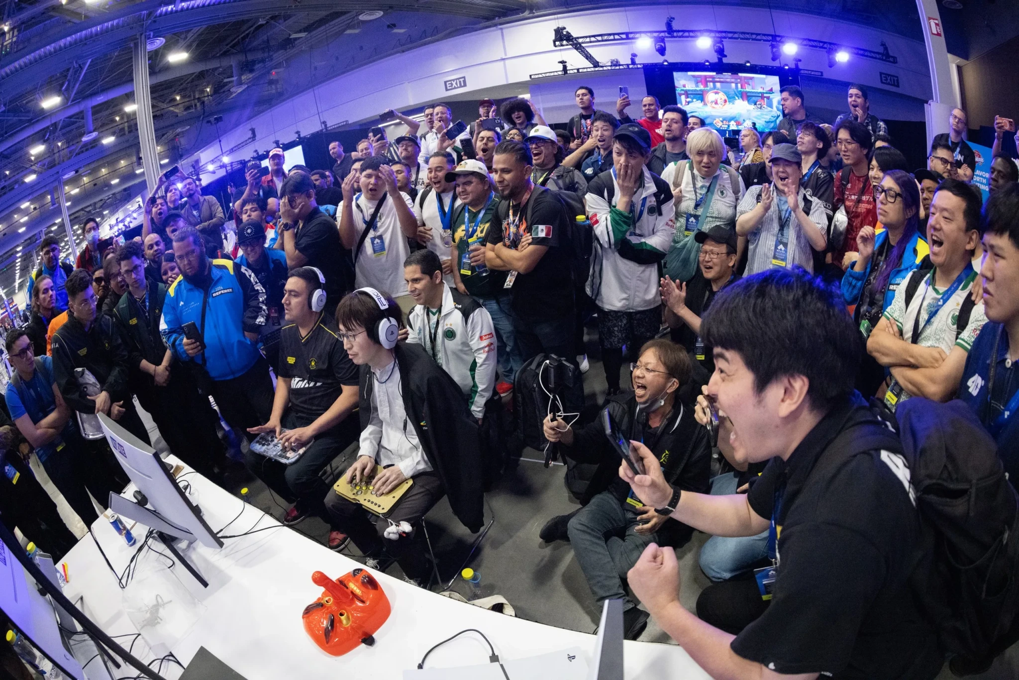 Spectators and gaming setups packed closely together at an Evo event