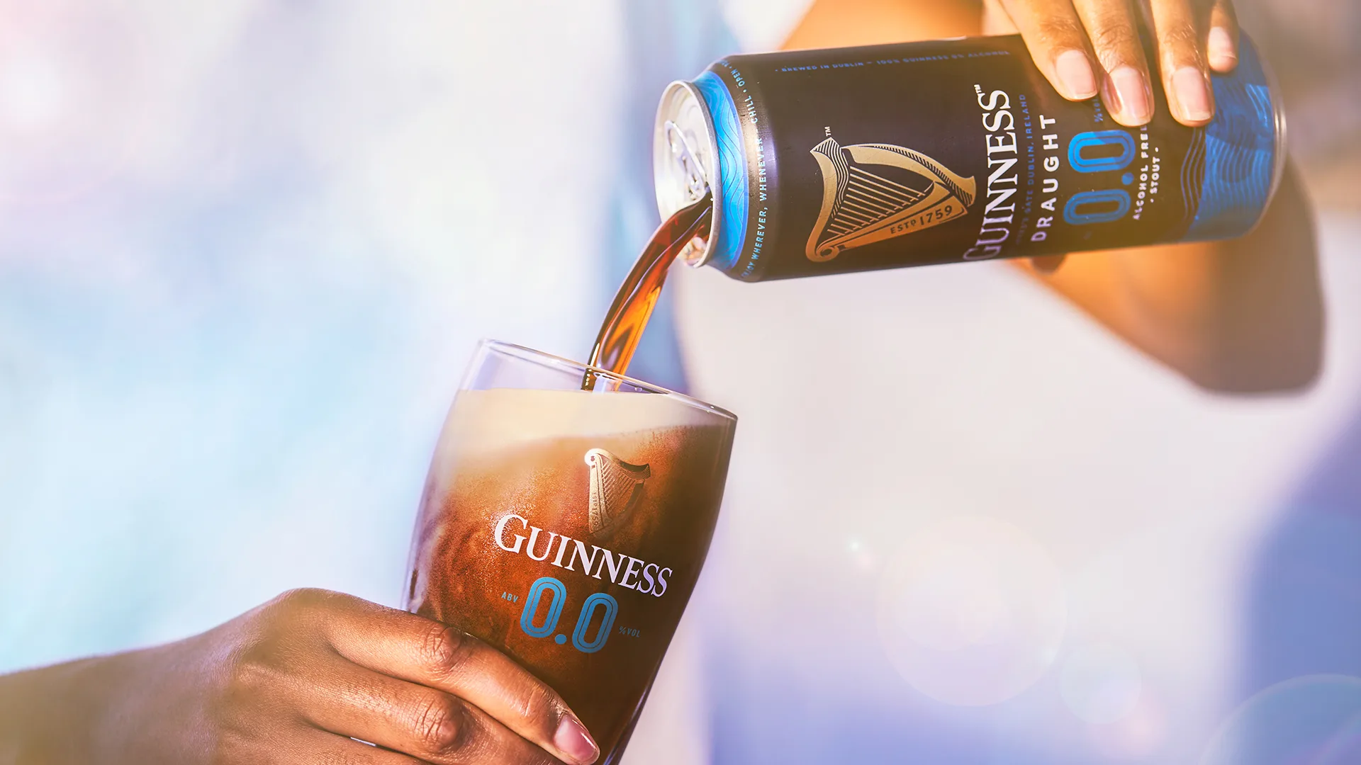 Guinness 0.0 being poured into a branded Guinness glass