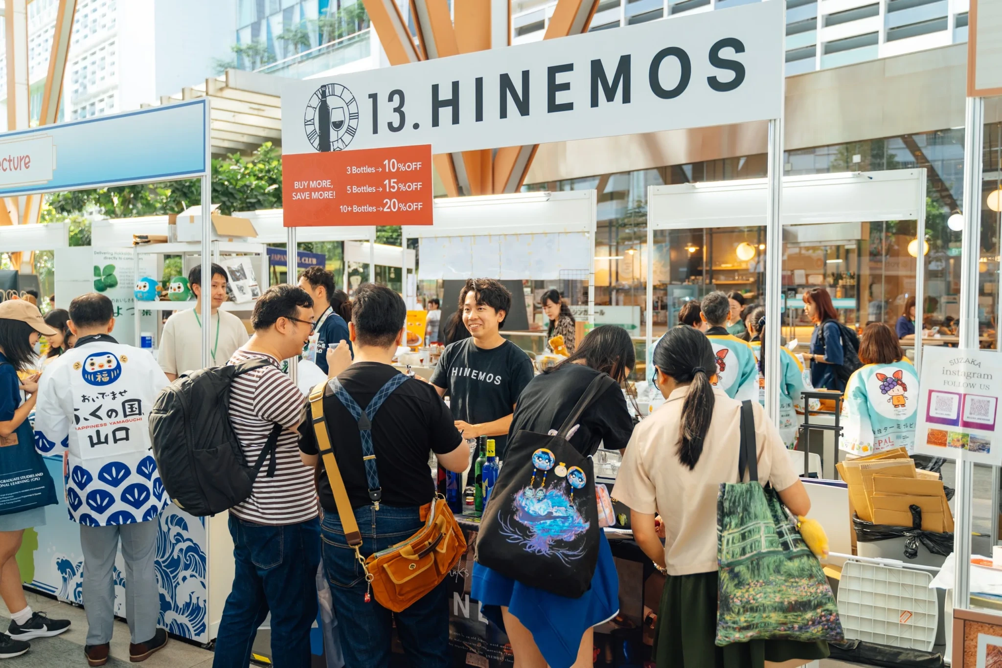 Booth with HIMENOS signage at TJRF, surrounded by visitors browsing products
