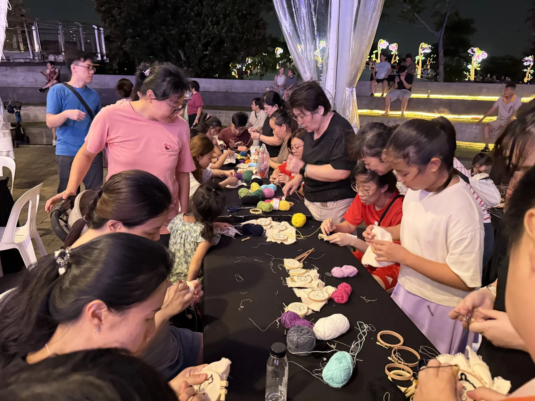 Residents of all ages crafting with yarn and textiles at Slow Threads, Wave Plaza