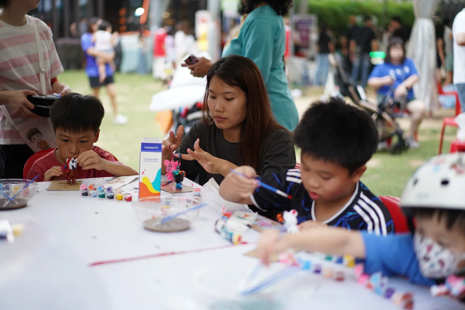 An art instructor guiding children through a hands-on art-making activity at PAssionArts Festival 2026