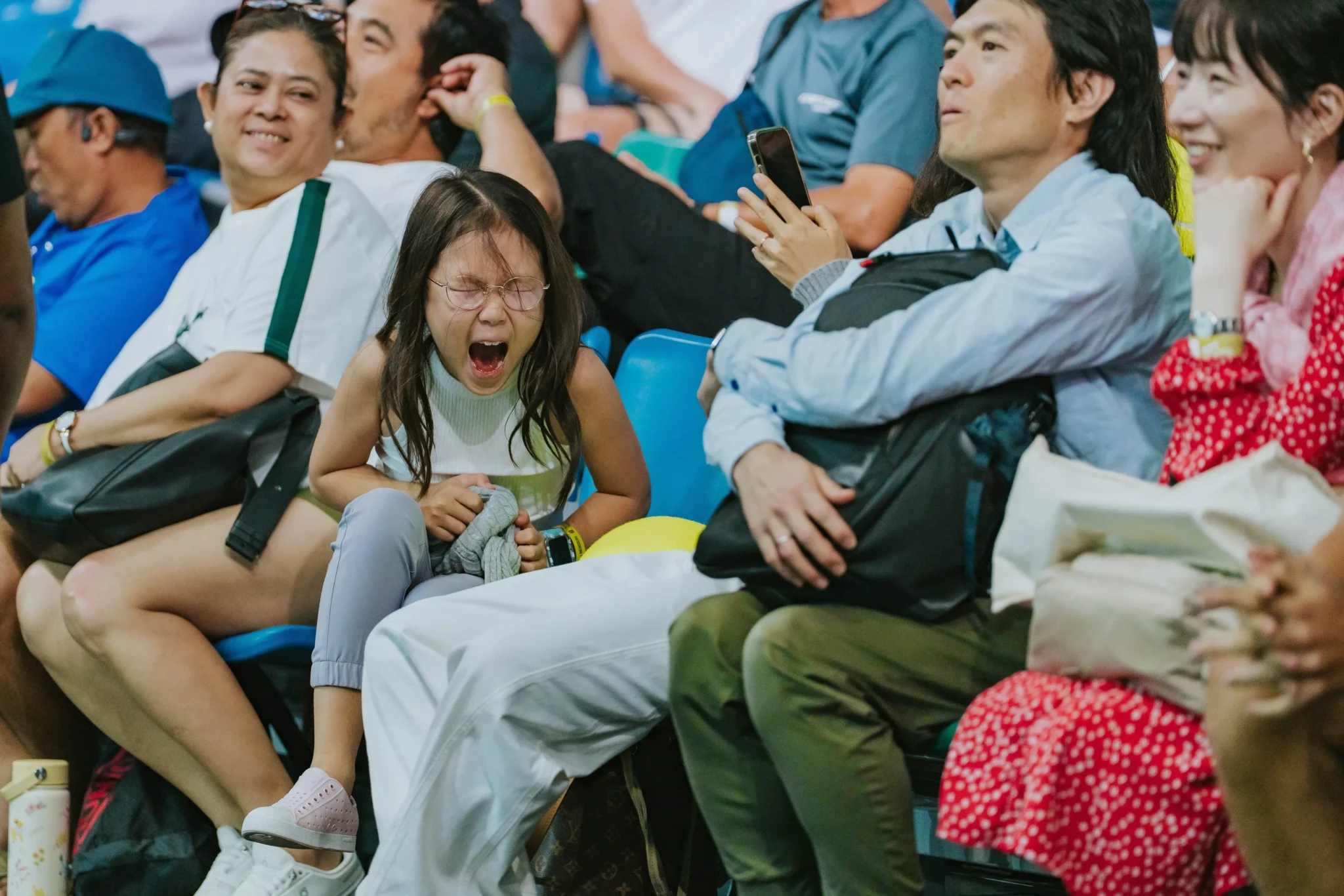 Young fan cheering in the stands at the Singapore Tennis Open semifinals