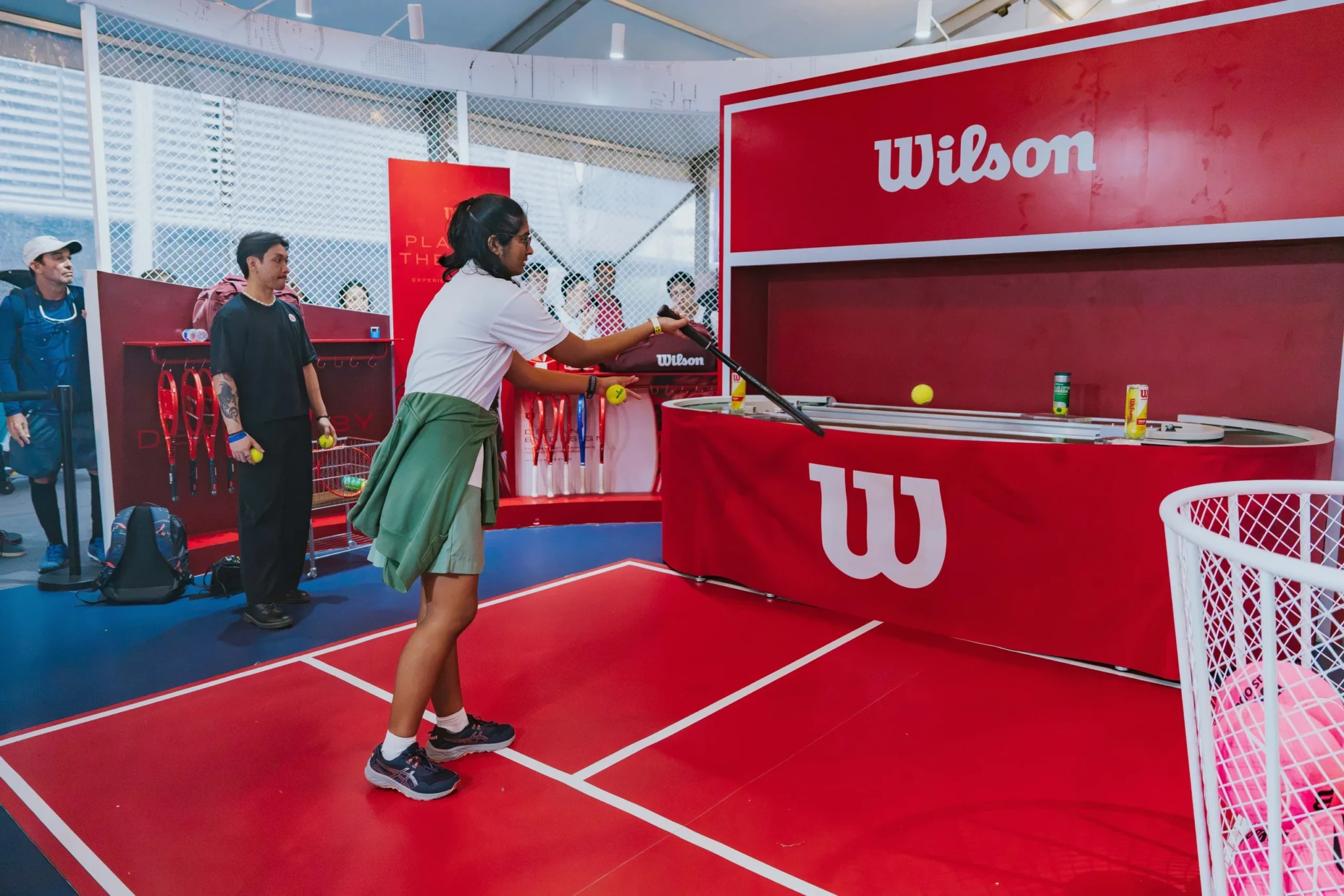 A visitor plays on the interactive Wilson tennis court at the Feel Alive Zone