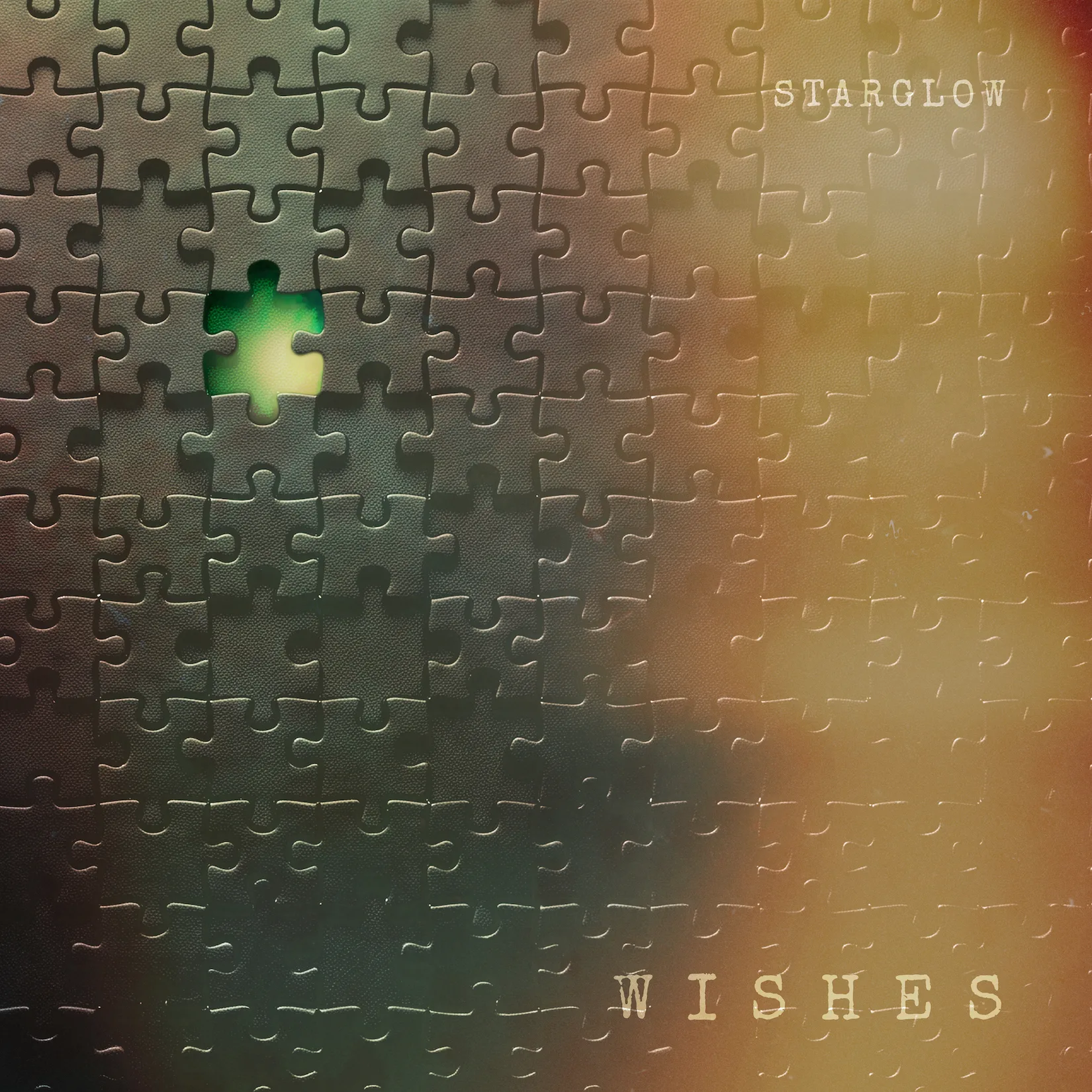 STARGLOW's WISHES single artwork showing a puzzle with one glowing green piece